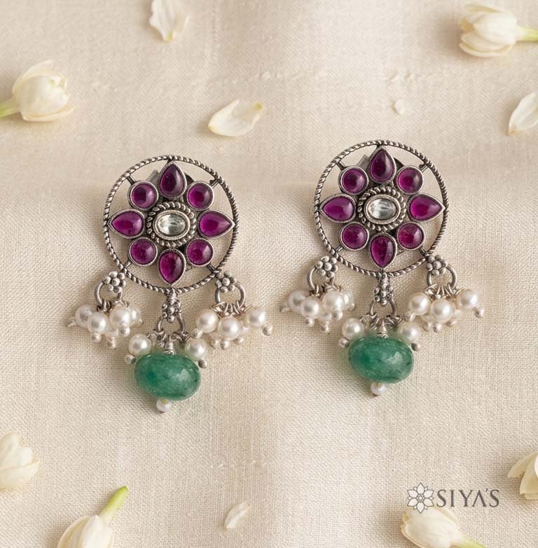 Red flower with pearl and green drop
